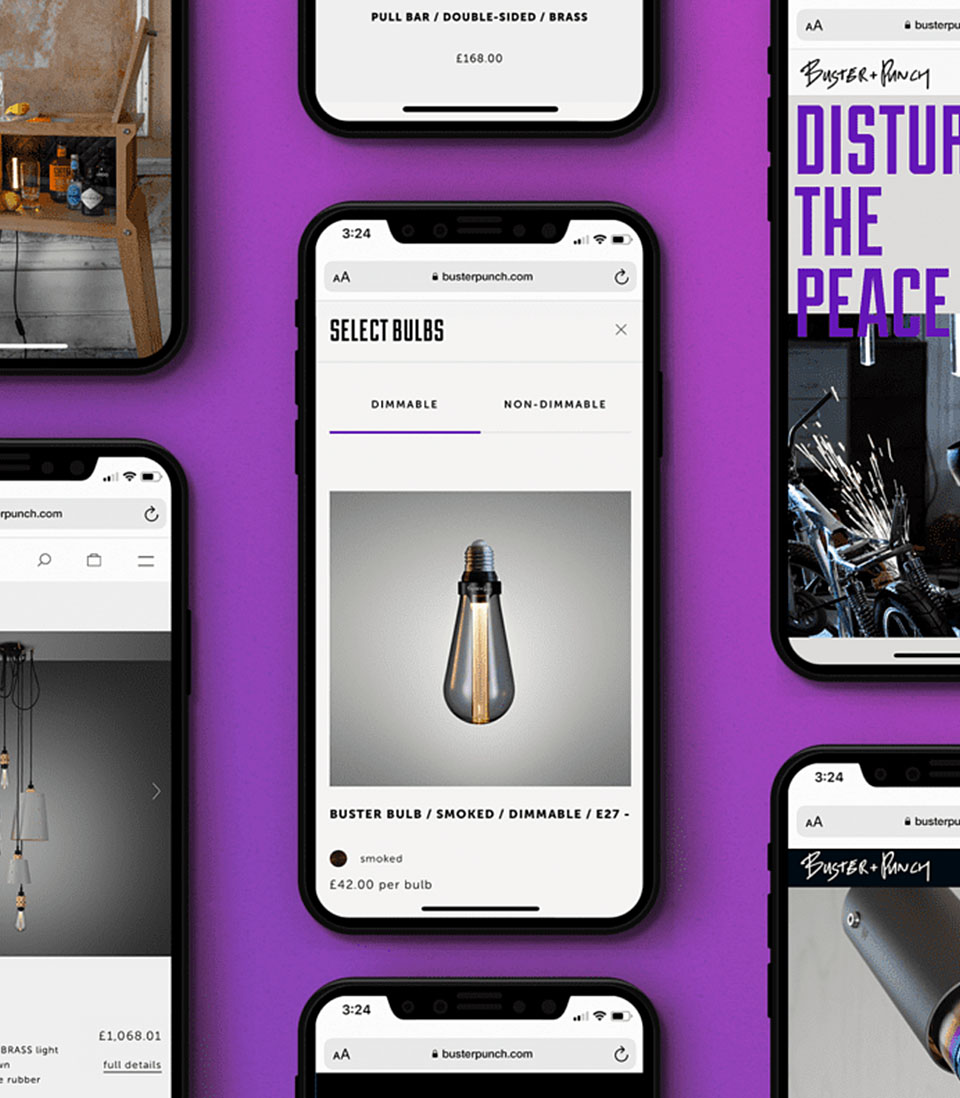 A set of smartphones displaying the Buster + Punch e-commerce website, showcasing product pages and branding against a bold purple background.