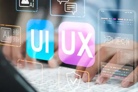 Hands typing on laptop with UI and UX interface icons overlayed on screen.
