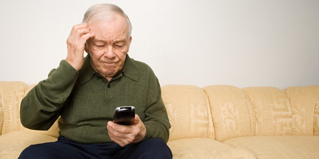 Confused elderly man with remote control