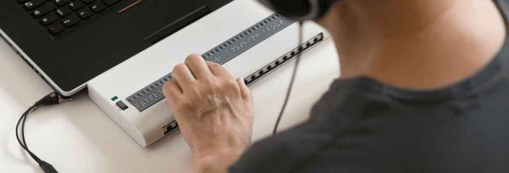 man using braille screen reader