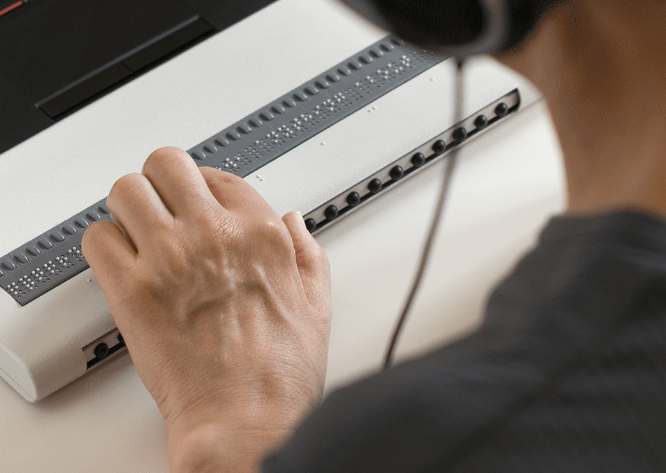 man using braille screen reader