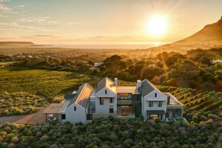 The Alexander Estate surrounded by vineyards at sunset with ocean and mountain views.